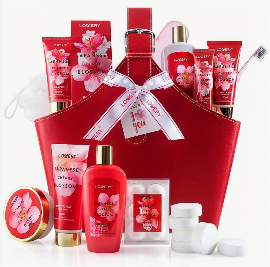 A red gift basket filled with Lofery Japanese Cherry Blossom body care products, including a body wash bottle, lotion tubes, a soap bar, a round tin, and small white jars, arranged on a white background.