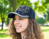 Woman wearing a navy blue cap with 'Life is Awesome' text in a park setting