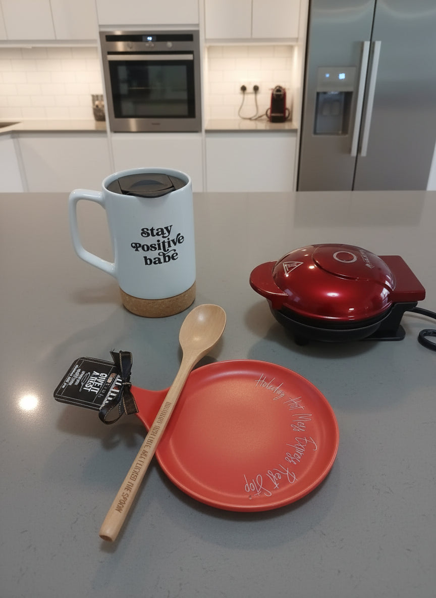 Kitchen counter with a mug, spoon, plate, and small appliance.