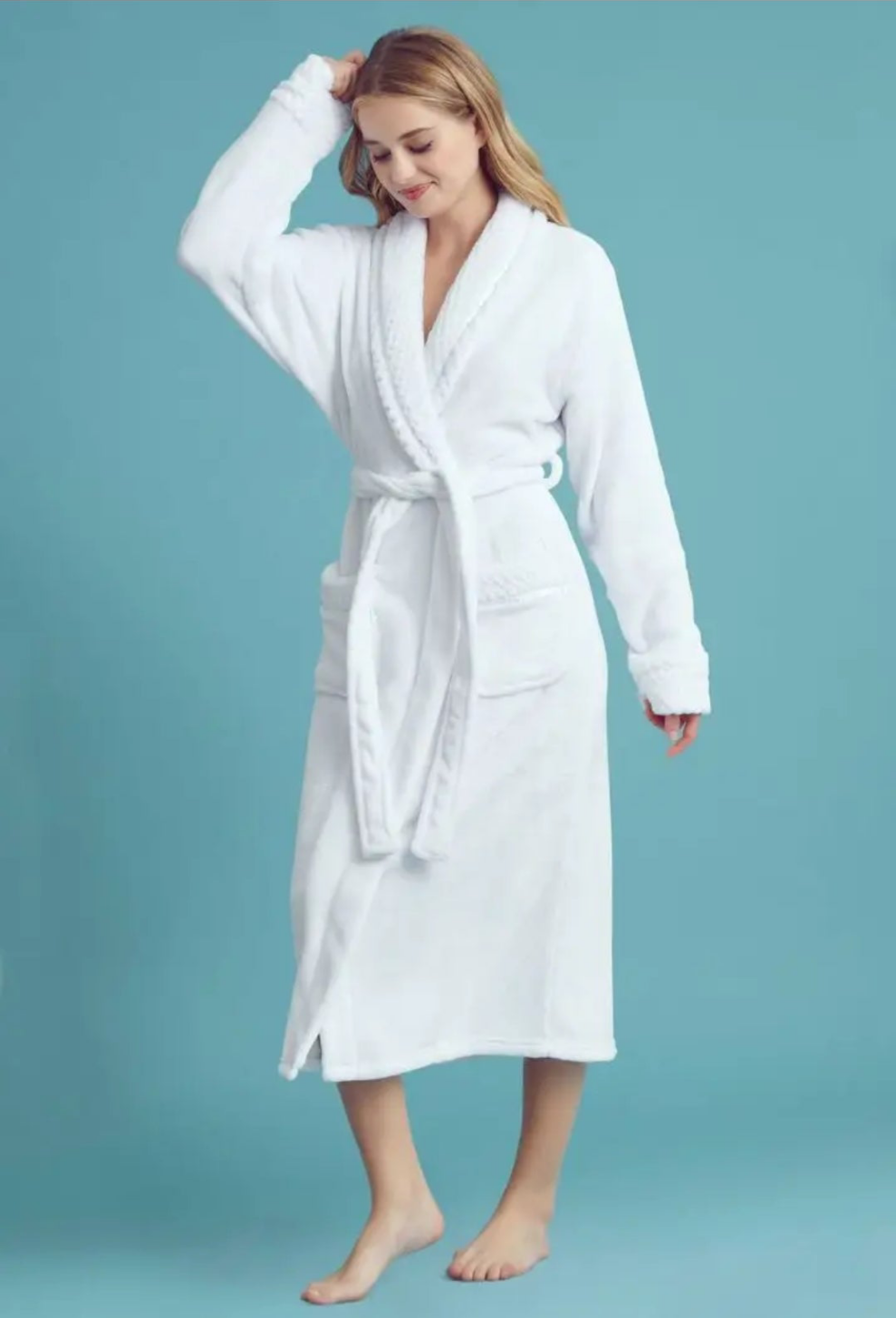 Woman wearing a white robe against a blue background