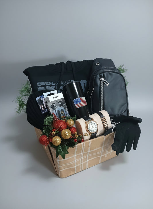 Gift basket with a black hoodie, mug, watch, and other items on a gray background