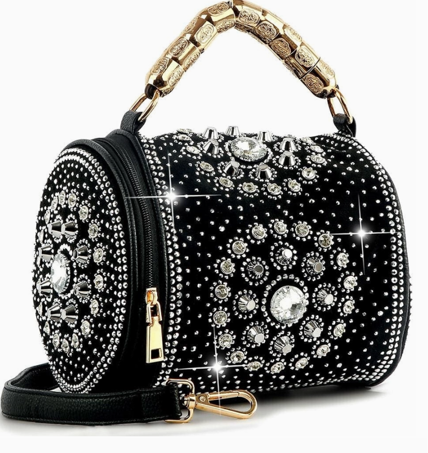 Black handbag with gold handle and embellished with crystals on a white background