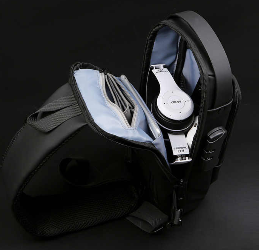Black backpack with a white device inside on a black background