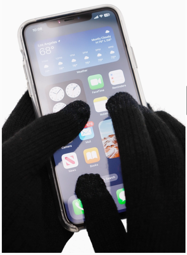 Person using a smartphone with touch screen gloves on a white background