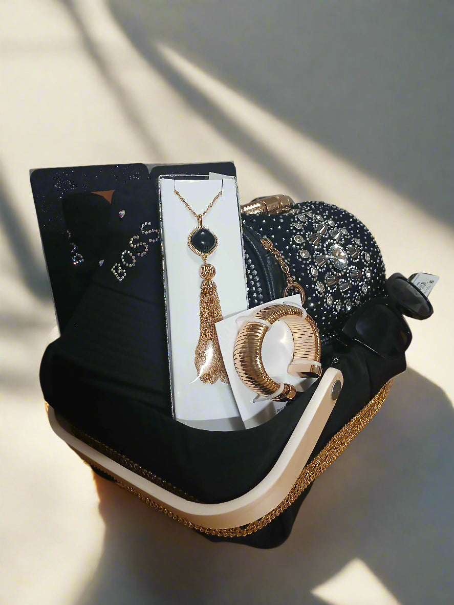Jewelry set including necklace, bracelet, and earrings on a black surface with a wooden background.