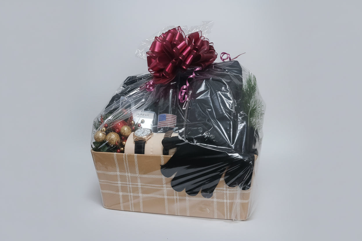 Gift basket with black items, a red bow, and Christmas decorations on a white background