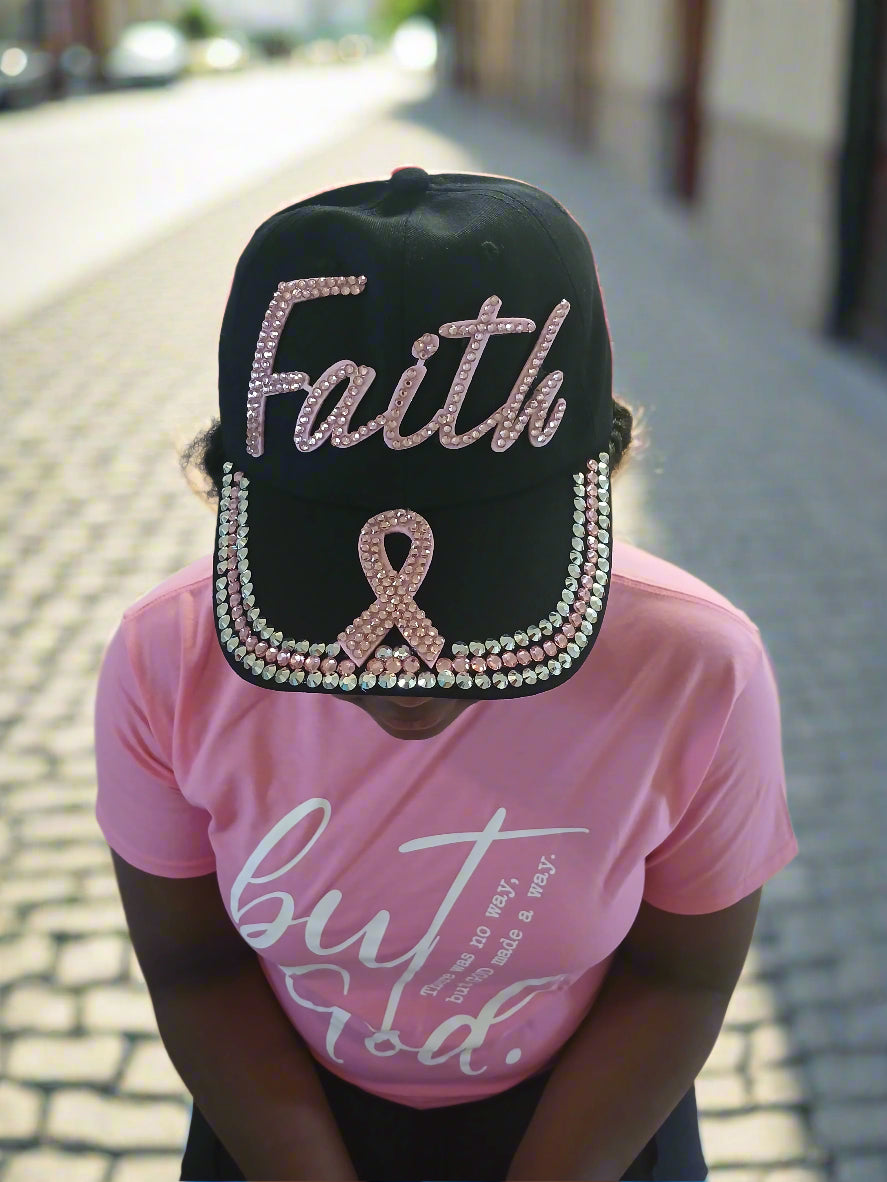 Person wearing a black cap with 'Faithf' and a pink shirt with text.