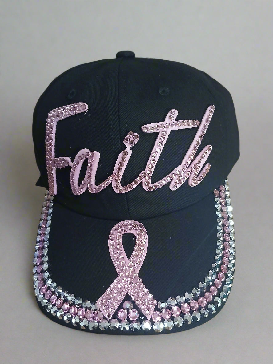 Black cap with pink and silver embellishments on a wooden surface