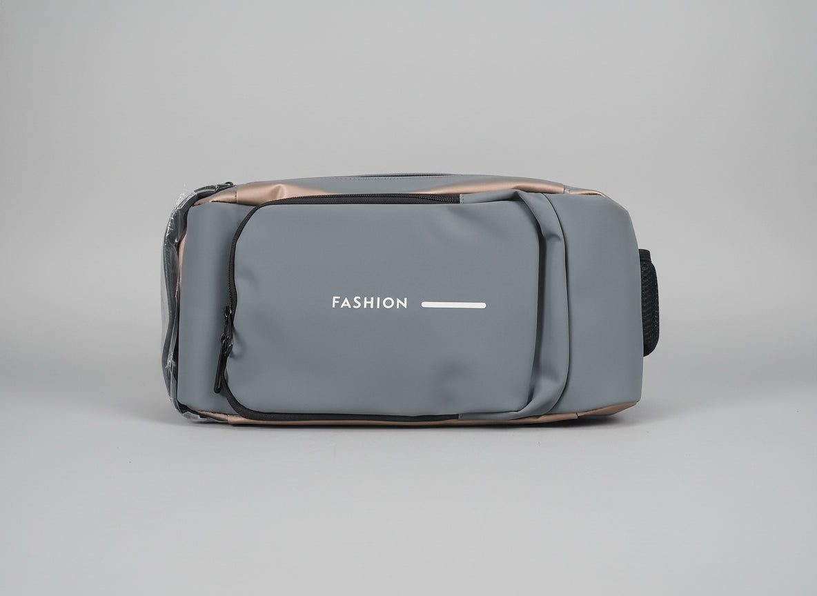 Gray crossbodyl bag with 'FASHION' text on a marble surface