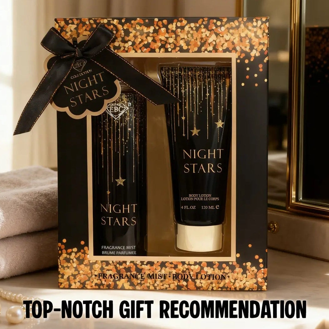 A boxed fragrance gift set labeled NIGHT STARS, featuring a black and gold glittery presentation box with a black ribbon, a tall black bottle, and a matching cylindrical tube, shown indoors with a warm neutral background.