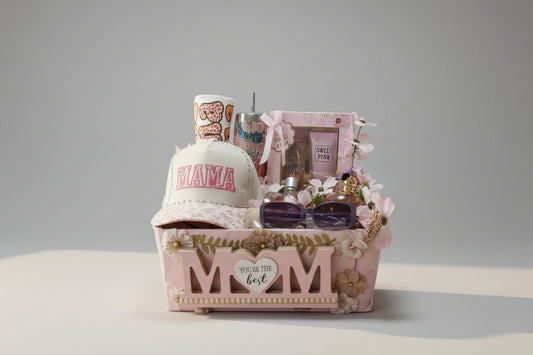Gift basket with 'Mama' hat, flowers, and other items in a modern living room.