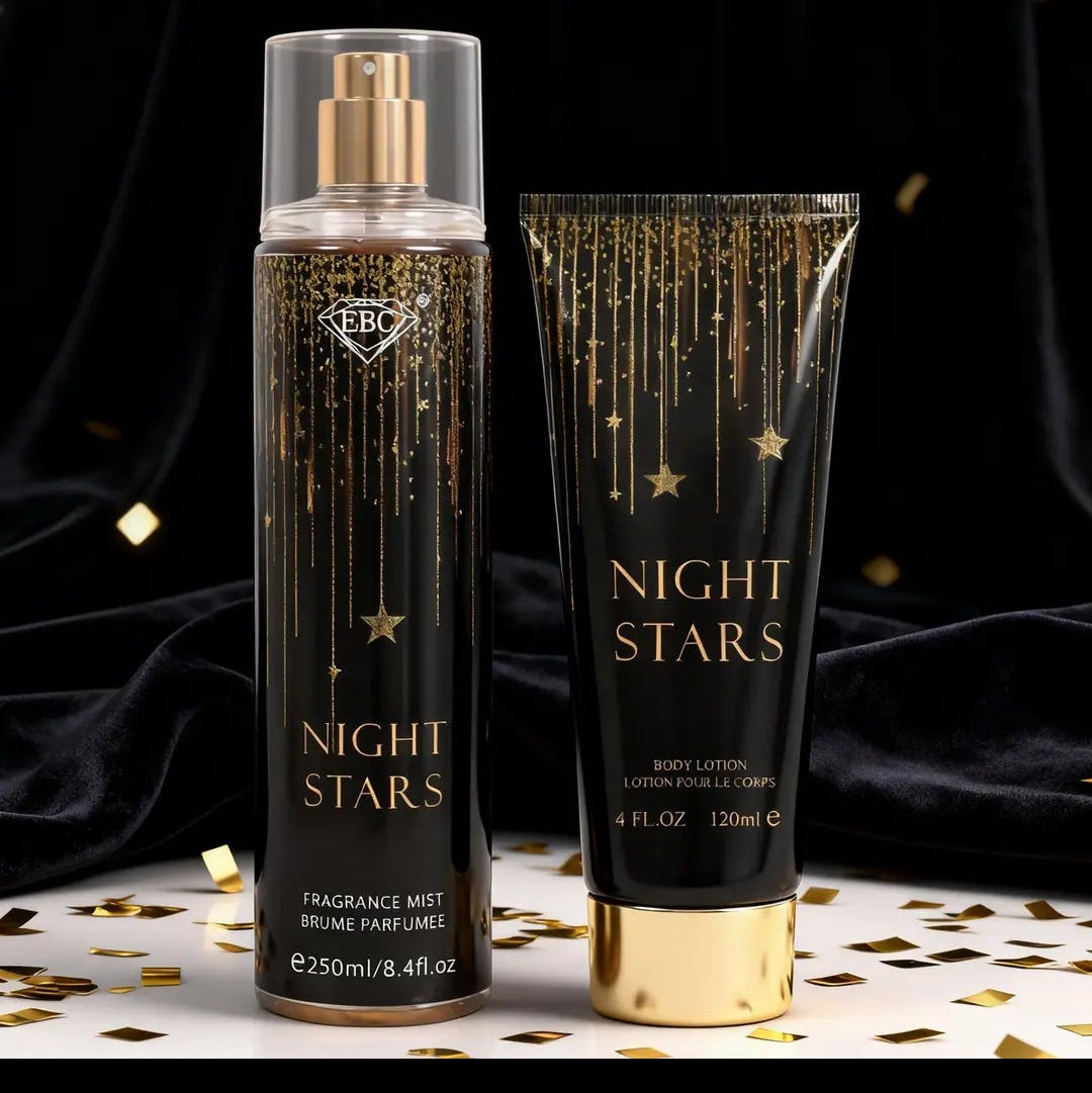 A perfume mist bottle and matching body lotion tube labeled NIGHT STARS, shown on a dark draped background with gold confetti. The packaging is black with gold lettering and star details, and both containers have gold caps.