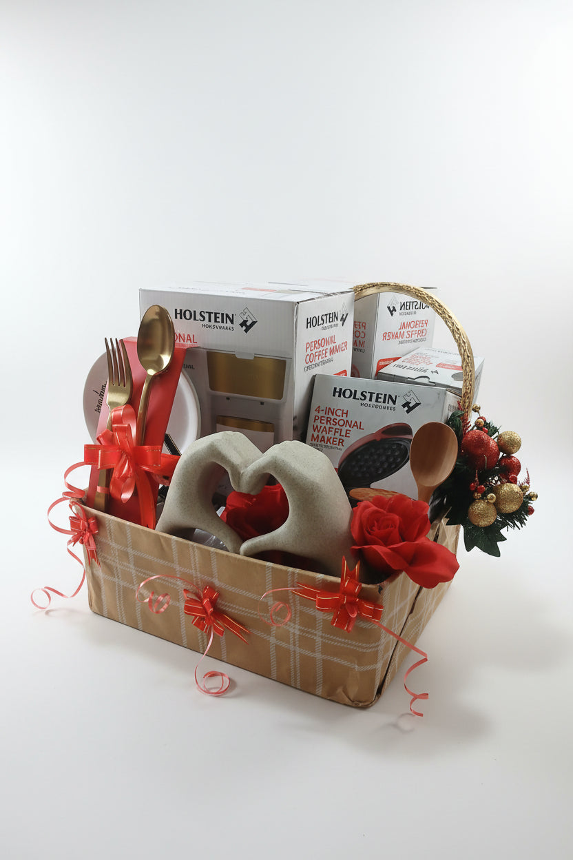 Decorative setup with Holsten coffee boxes, a heart-shaped container, and red flowers on a wooden surface.